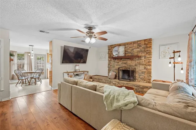 a living room with furniture a flat screen tv and a fireplace