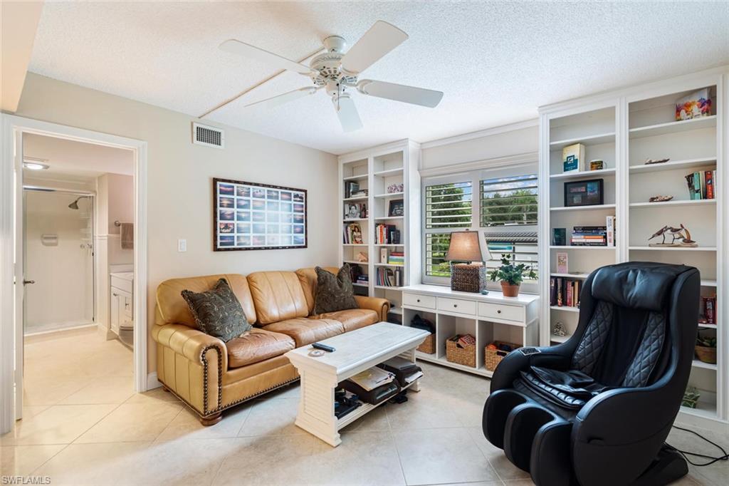 4155 Crayton Road, Unit 201 Naples, FL 34103 - Photo 16 of 24 a living room with furniture rug and a large window