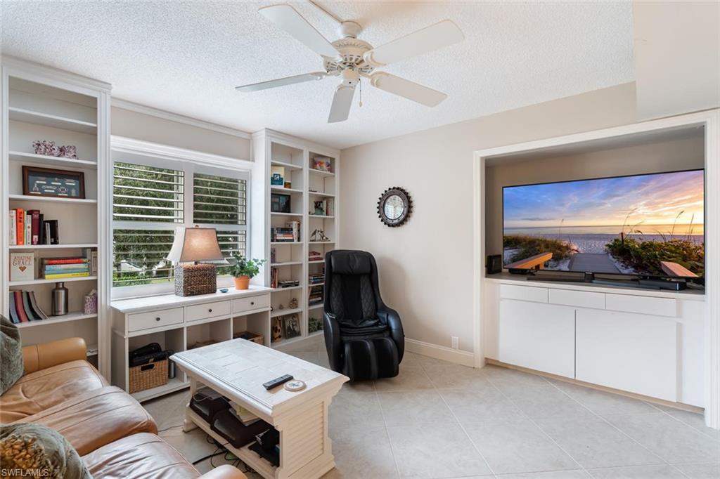 4155 Crayton Road, Unit 201 Naples, FL 34103 - Photo 17 of 24 a room with furniture a rug and a window