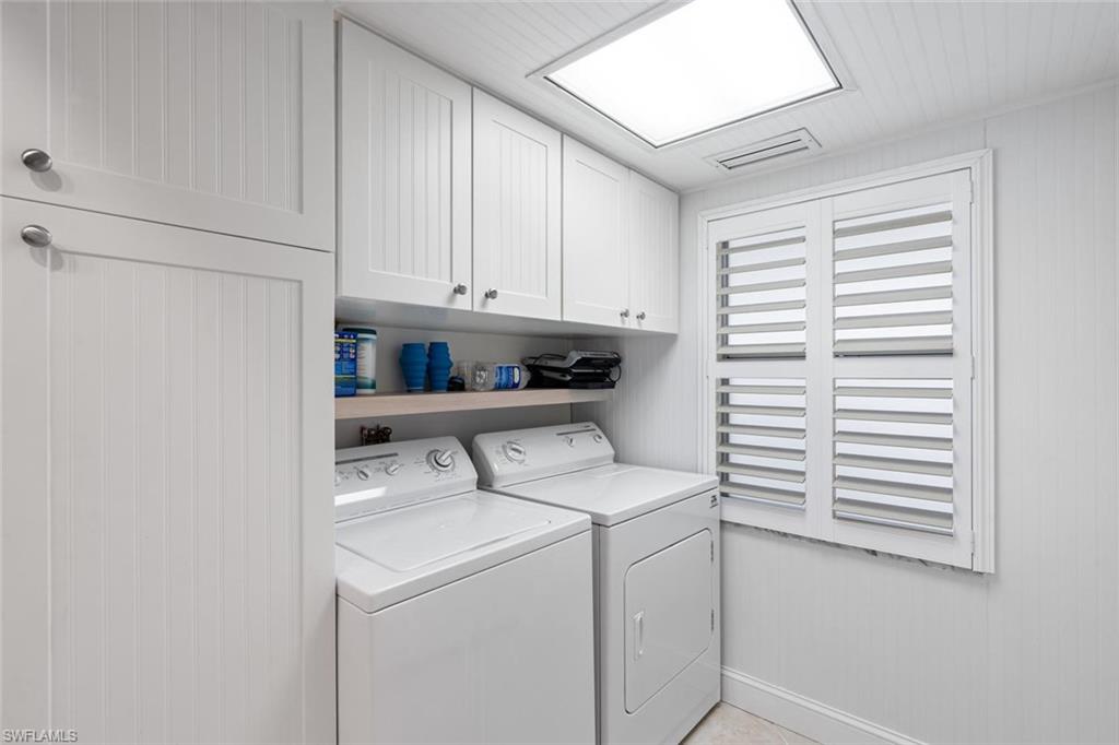 4155 Crayton Road, Unit 201 Naples, FL 34103 - Photo 20 of 24 a view of storage and utility room with washer and dryer