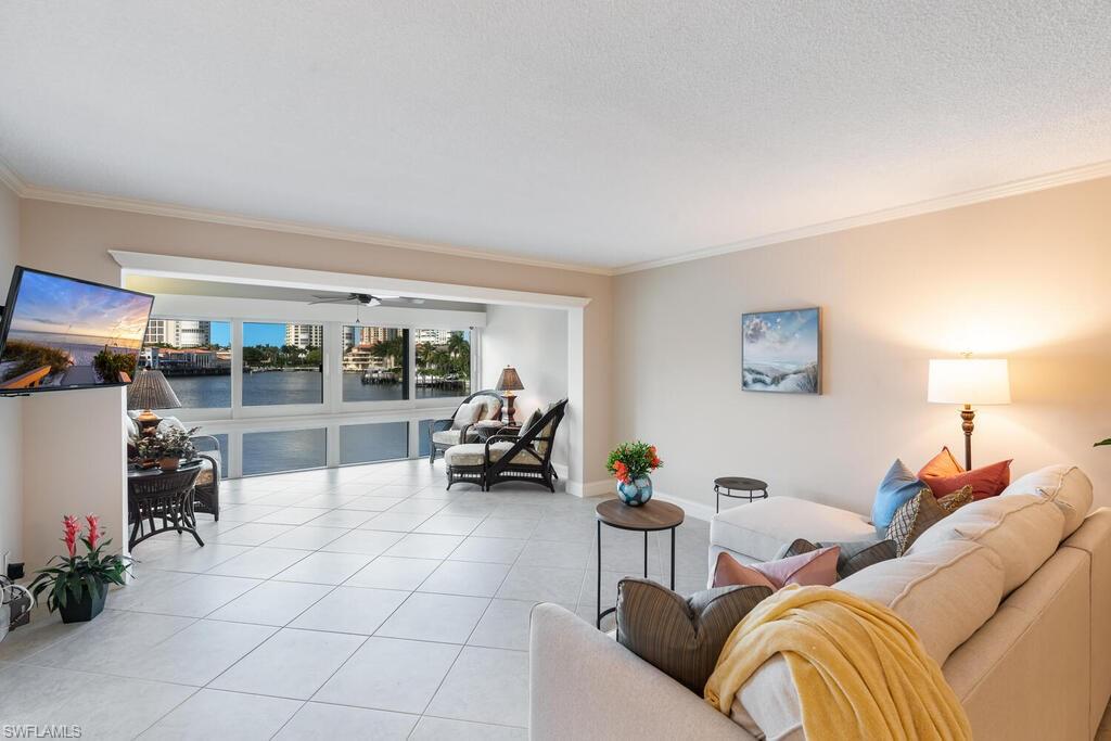 4155 Crayton Road, Unit 201 Naples, FL 34103 - Photo 2 of 24 a bedroom with furniture and a potted plant