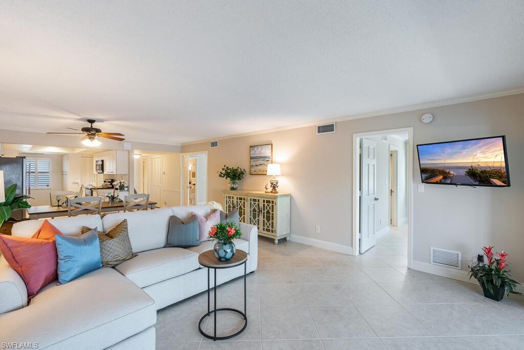 4155 Crayton Road, Unit 201 Naples, FL 34103 - Photo 3 of 24 a living room with furniture and a flat screen tv