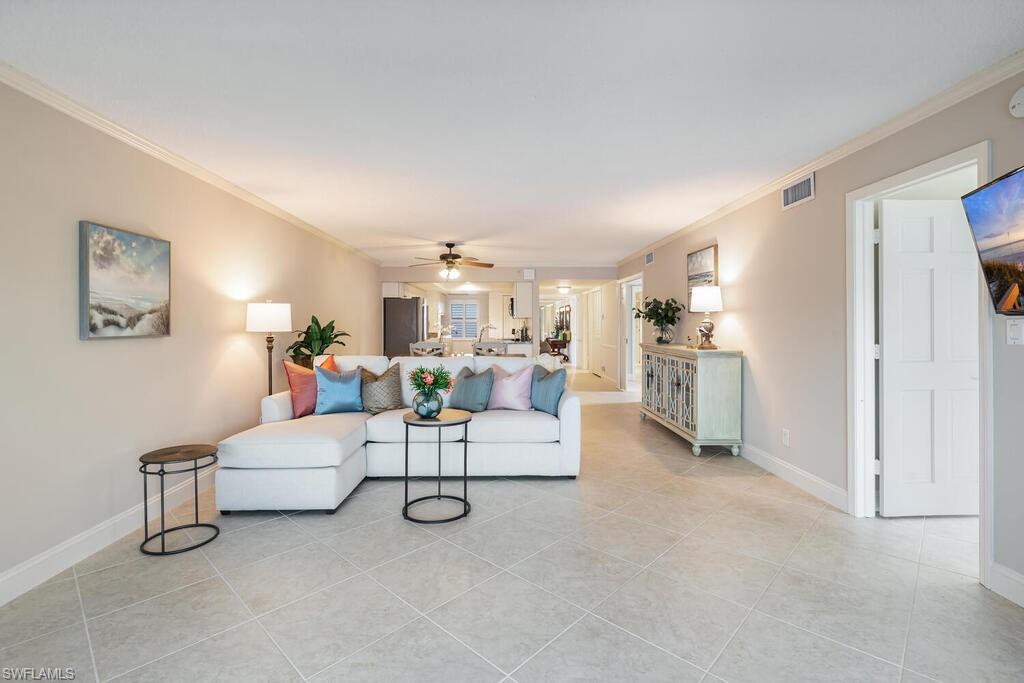 4155 Crayton Road, Unit 201 Naples, FL 34103 - Photo 4 of 24 a living room with furniture and kitchen view