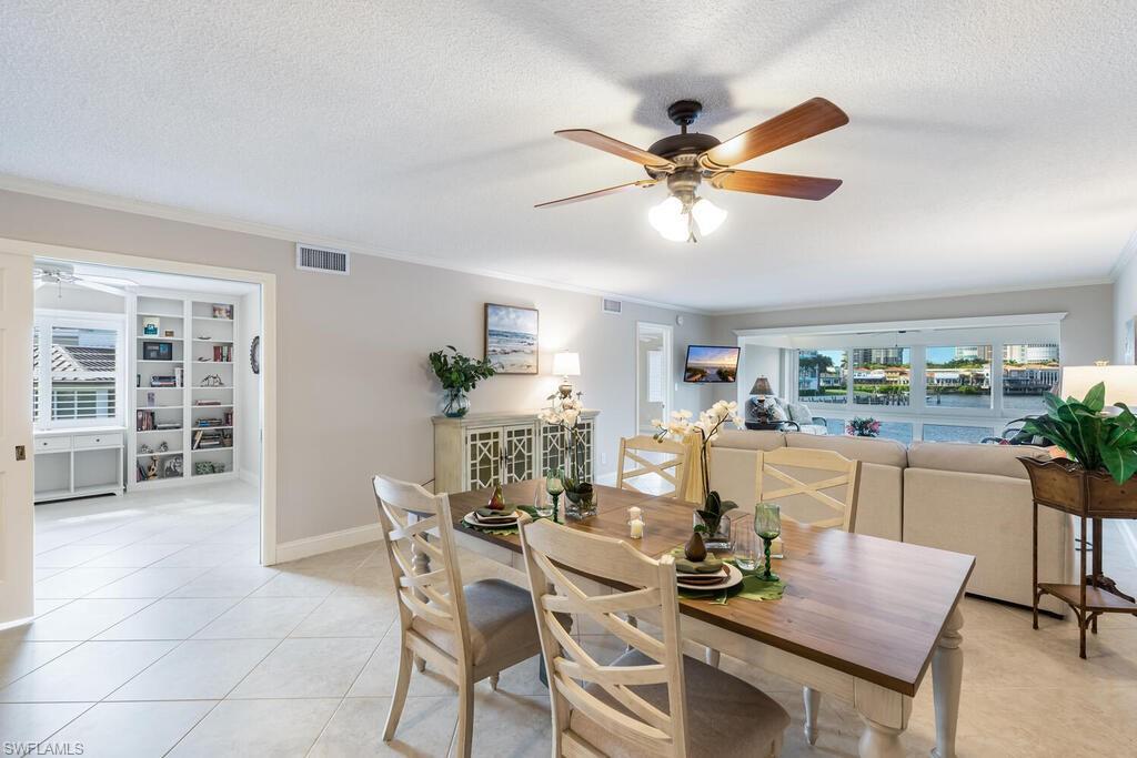 4155 Crayton Road, Unit 201 Naples, FL 34103 - Photo 6 of 24 a dining room with furniture and window