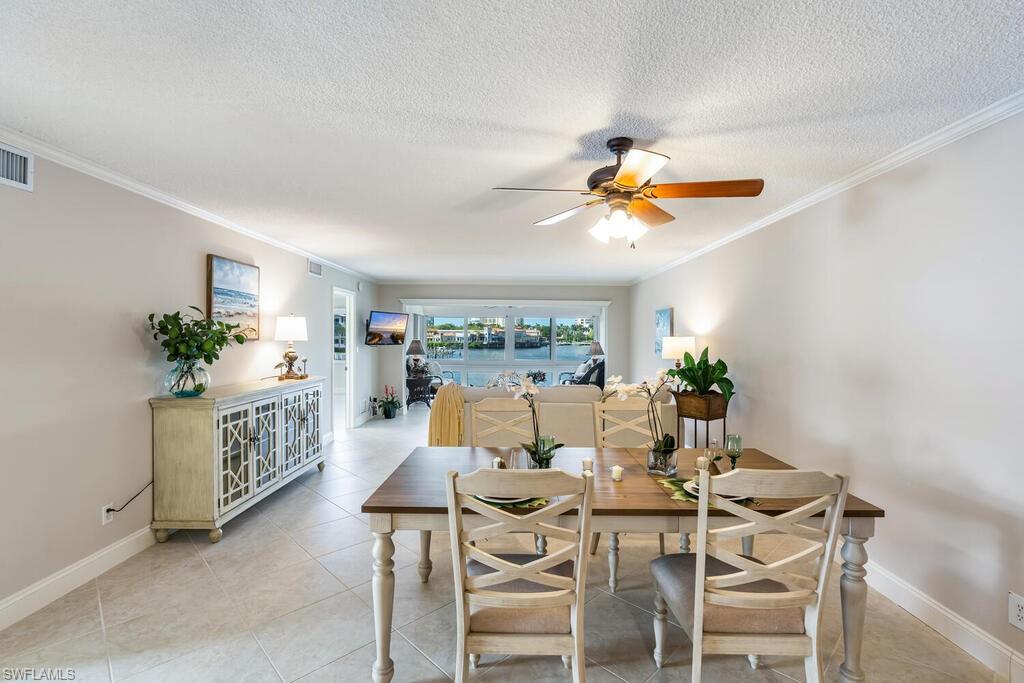 4155 Crayton Road, Unit 201 Naples, FL 34103 - Photo 9 of 24 a view of a dining room with furniture window and outside view