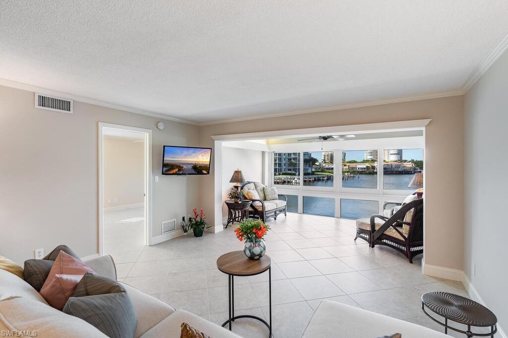 4155 Crayton Road, Unit 201 Naples, FL 34103 - Photo 10 of 24 a living room with furniture and a large window