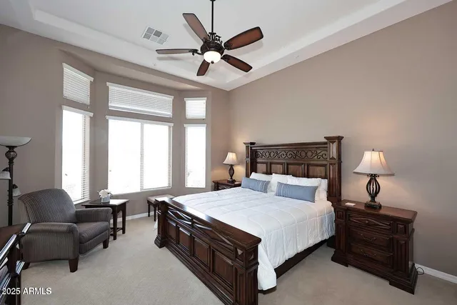 a spacious bedroom with a bed and a couch