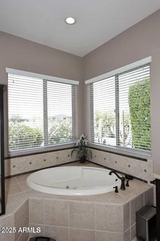 a bath tub sitting in a bathroom next to a window