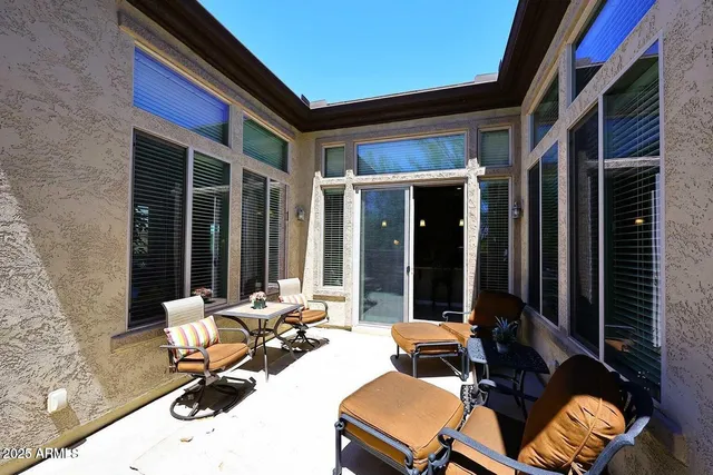 a view of a dinning room with chairs and floor to ceiling window