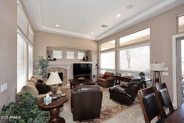 a living room with furniture fireplace and a large window