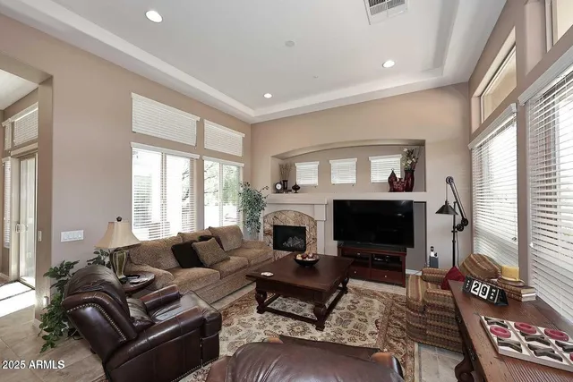 a living room with furniture a flat screen tv and a fireplace