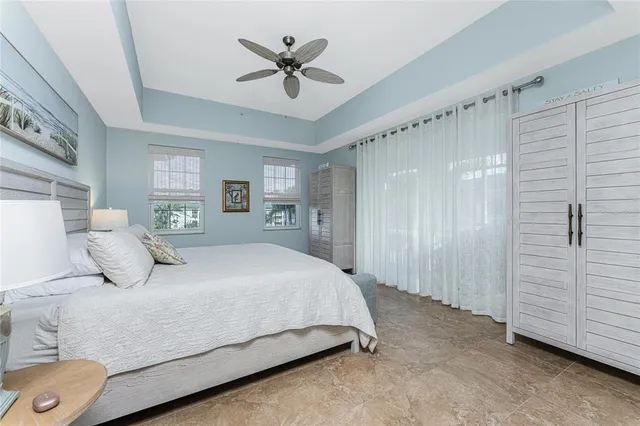 a bedroom with a large bed and a chandelier