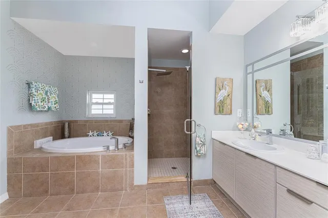 a bathroom with a tub sink and mirror