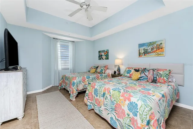 a bedroom with two beds and a flat screen tv