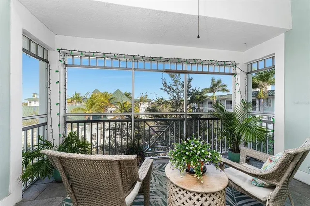 a balcony with furniture and a potted plant