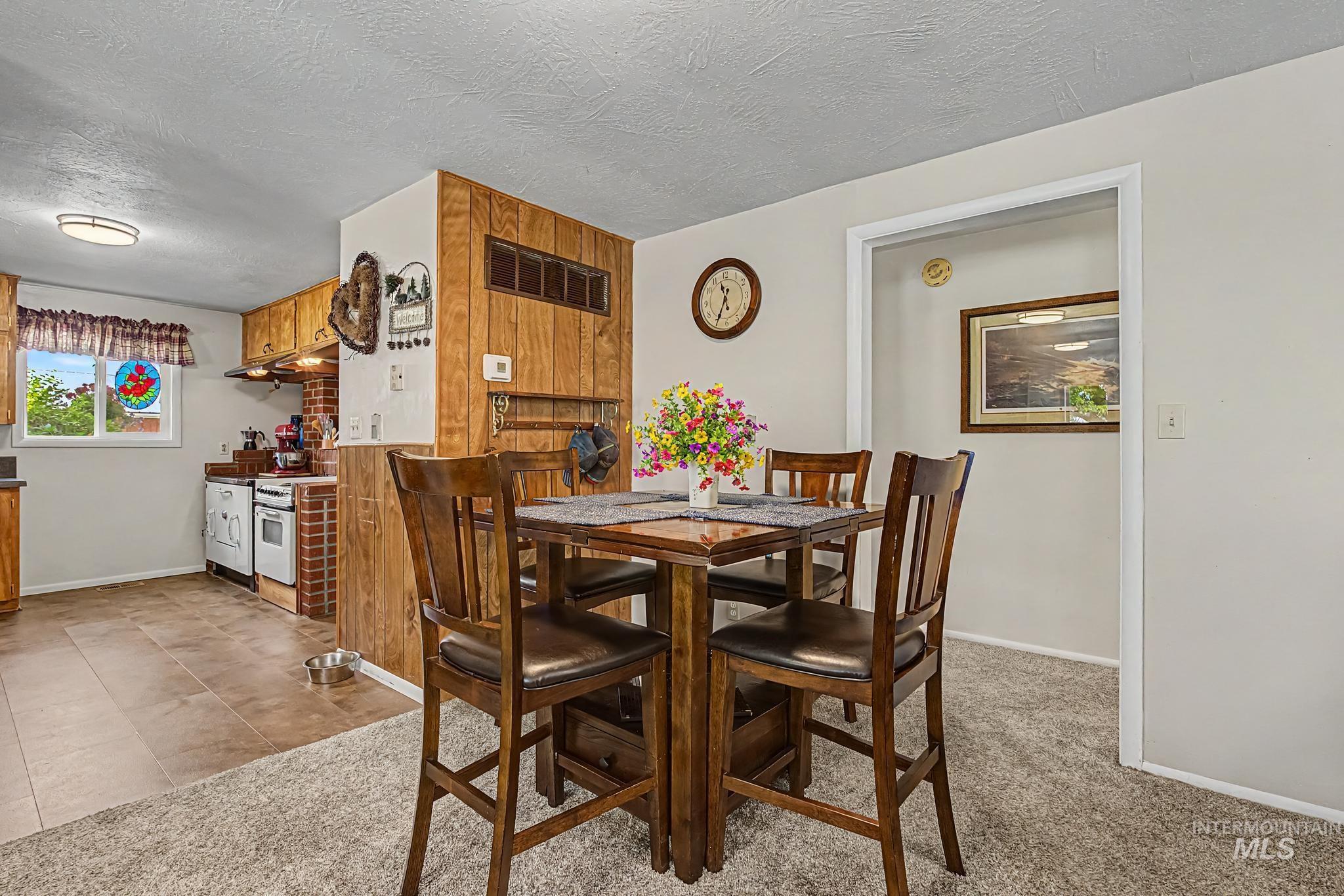 4311 Frozen Dog Road Emmett, ID 83617 - Photo 20 of 31 Kitchen featuring wood cabinetry, brick-look backsplash, and a window for natural light