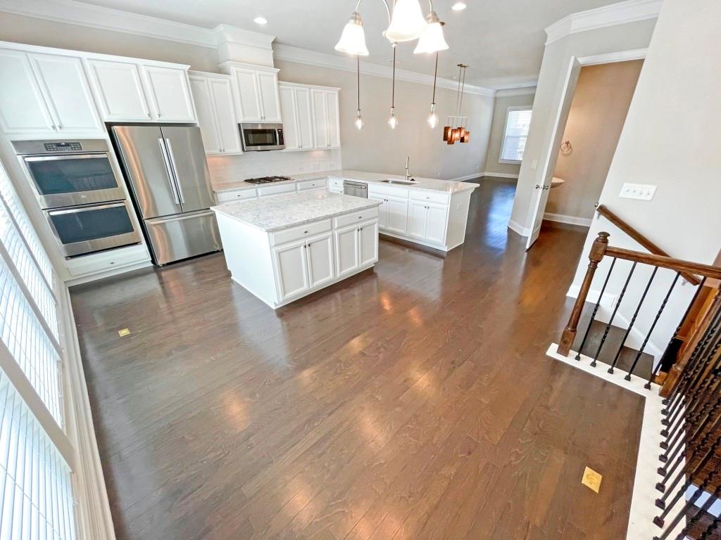 4129 Townsend Lane Dunwoody, GA 30346 - Photo 6 of 38 a large white kitchen with stainless steel appliances a refrigerator