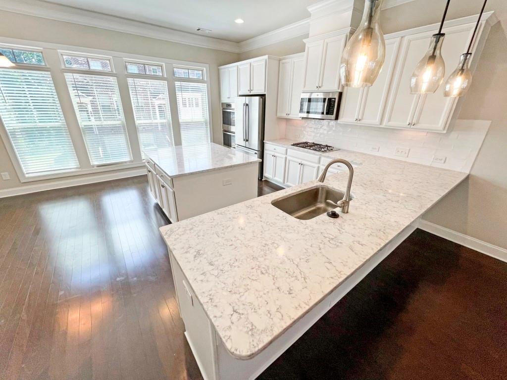 4129 Townsend Lane Dunwoody, GA 30346 - Photo 7 of 38 a kitchen with a sink a large window and stainless steel appliances