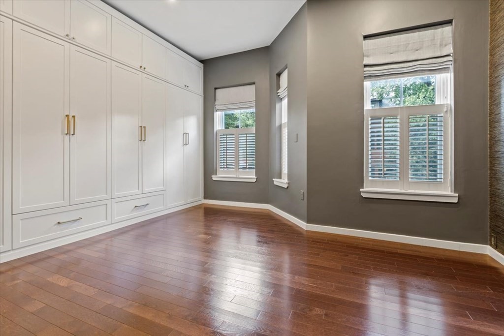 54 Appleton Street, Unit 4 Boston, MA 02116 - Photo 17 of 20 a view of an empty room with wooden floor and a window