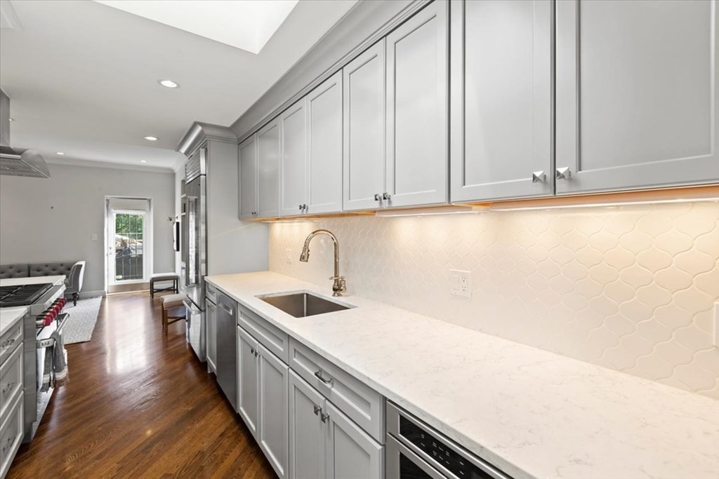 54 Appleton Street, Unit 4 Boston, MA 02116 - Photo 4 of 20 a kitchen with granite countertop a sink and white cabinets