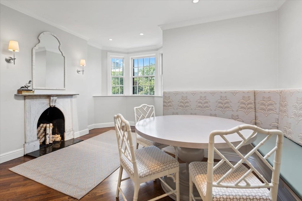 54 Appleton Street, Unit 4 Boston, MA 02116 - Photo 8 of 20 a view of a dining room with furniture and a fireplace