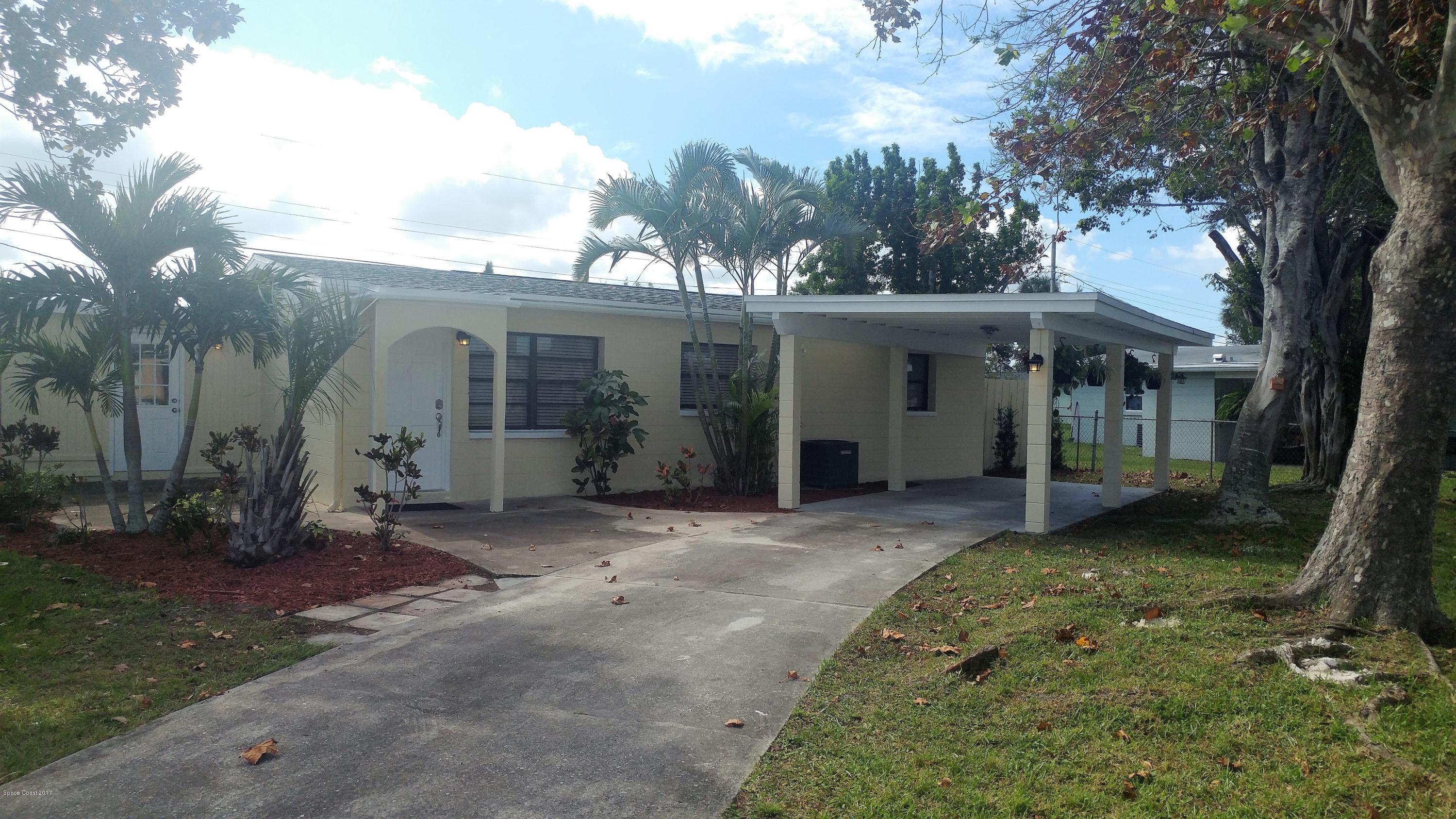 2857 Tropic Road Melbourne, FL 32935 - Photo 2 of 28 front view of a house with a yard