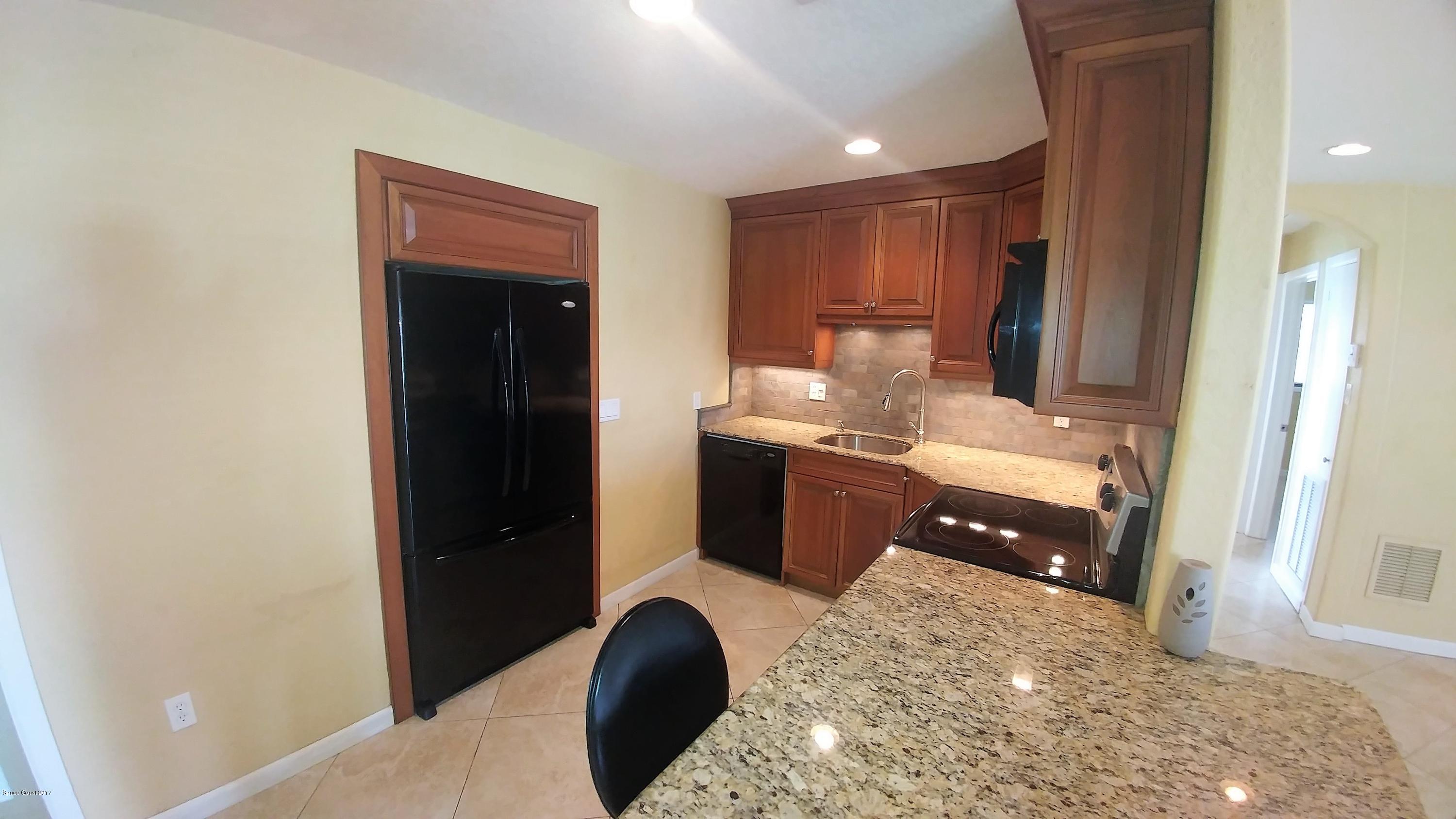 2857 Tropic Road Melbourne, FL 32935 - Photo 16 of 28 a bathroom with a sink and a mirror