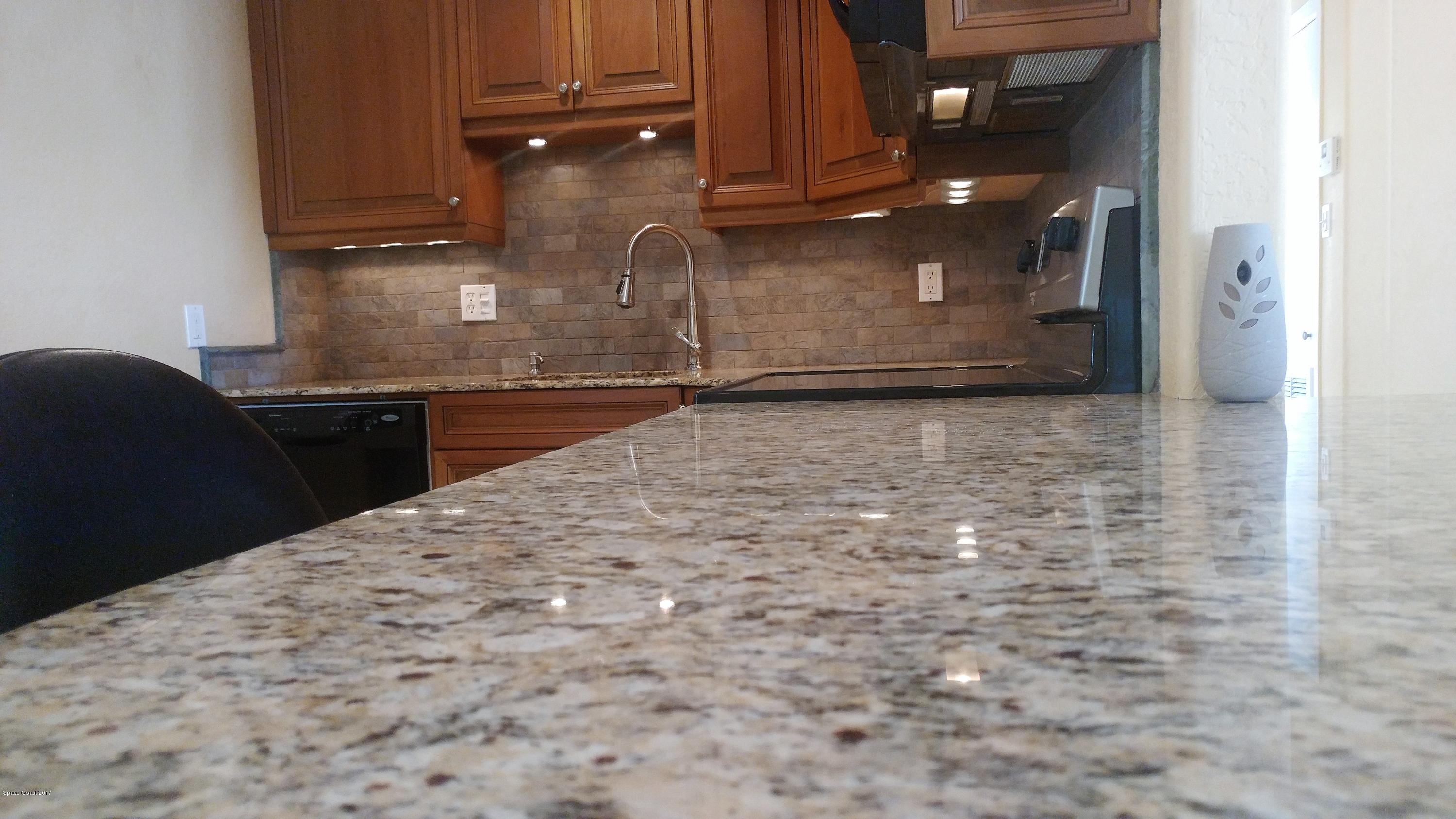 2857 Tropic Road Melbourne, FL 32935 - Photo 18 of 28 a view of kitchen with granite countertop cabinets