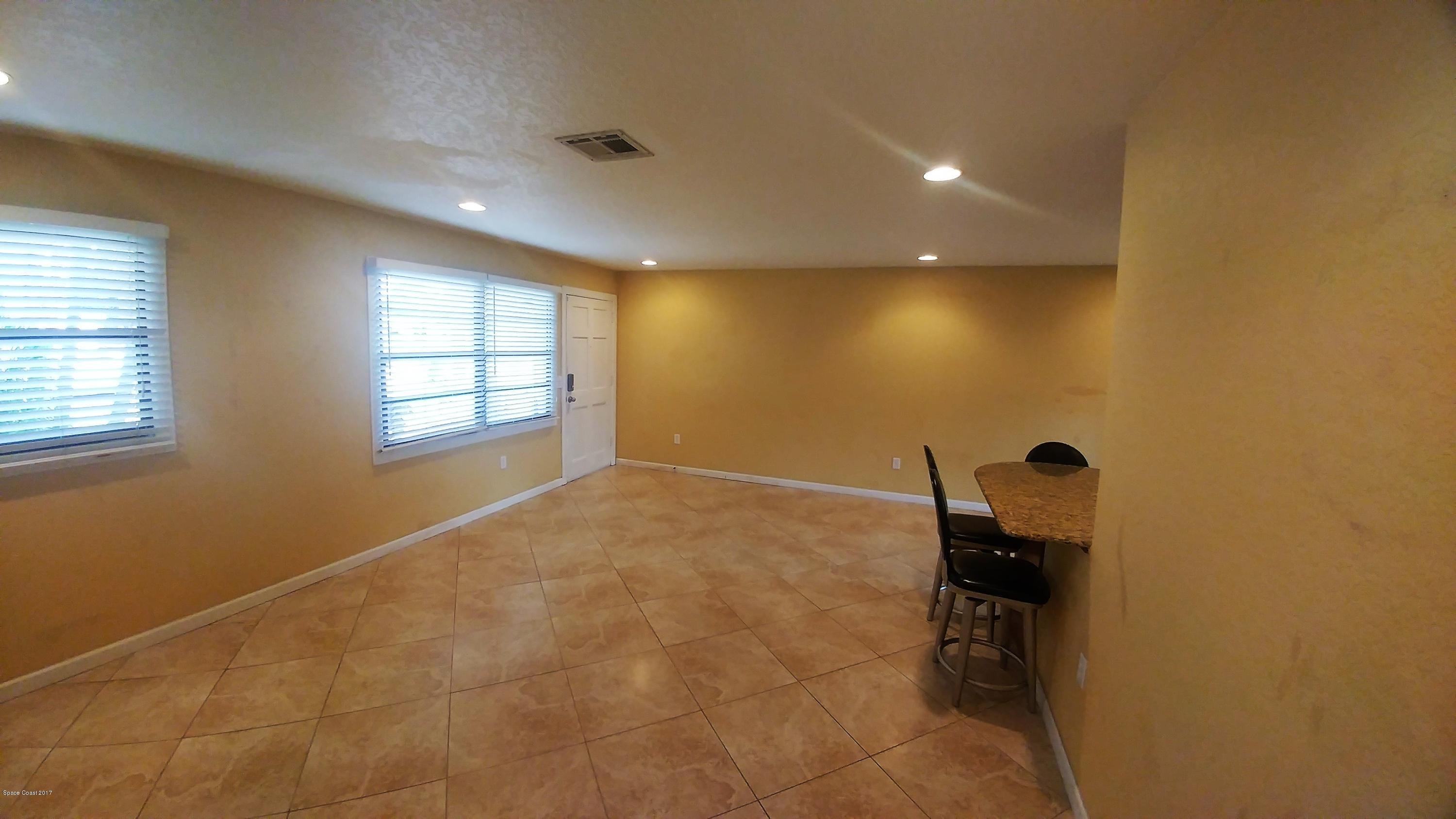 2857 Tropic Road Melbourne, FL 32935 - Photo 21 of 28 an empty room with windows and cabinet