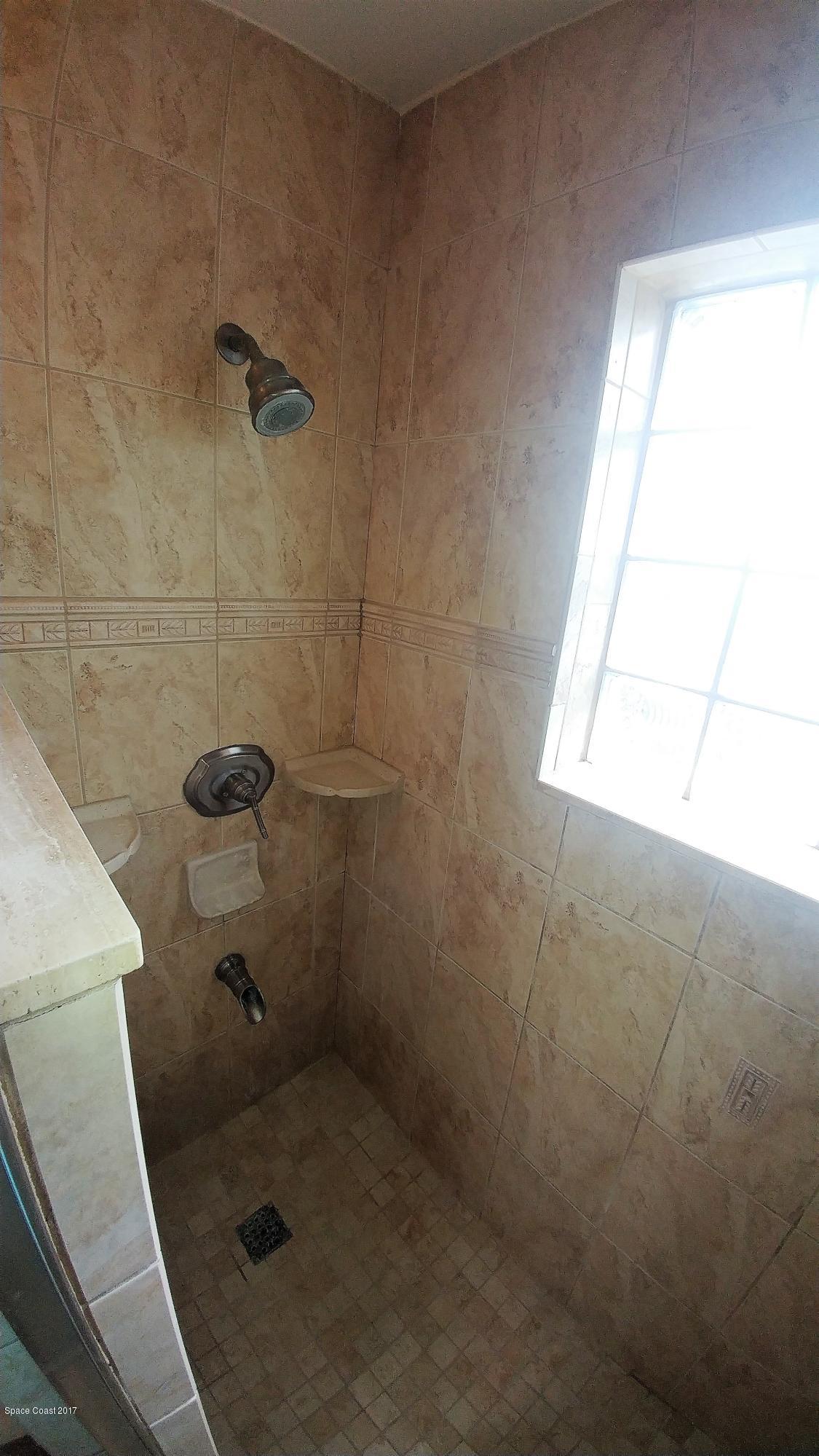 2857 Tropic Road Melbourne, FL 32935 - Photo 23 of 28 a bathroom with a shower