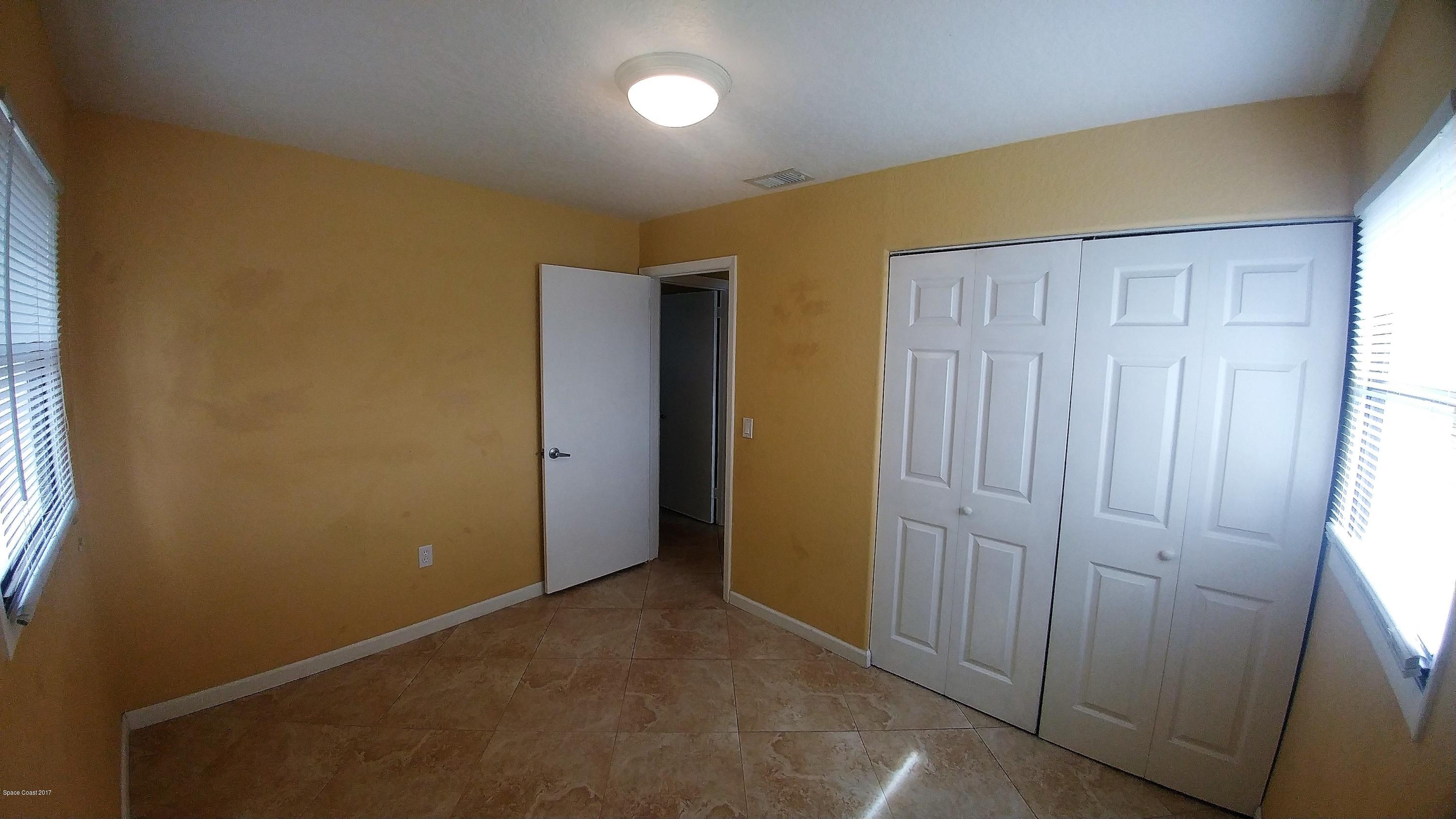 2857 Tropic Road Melbourne, FL 32935 - Photo 25 of 28 an empty room with windows