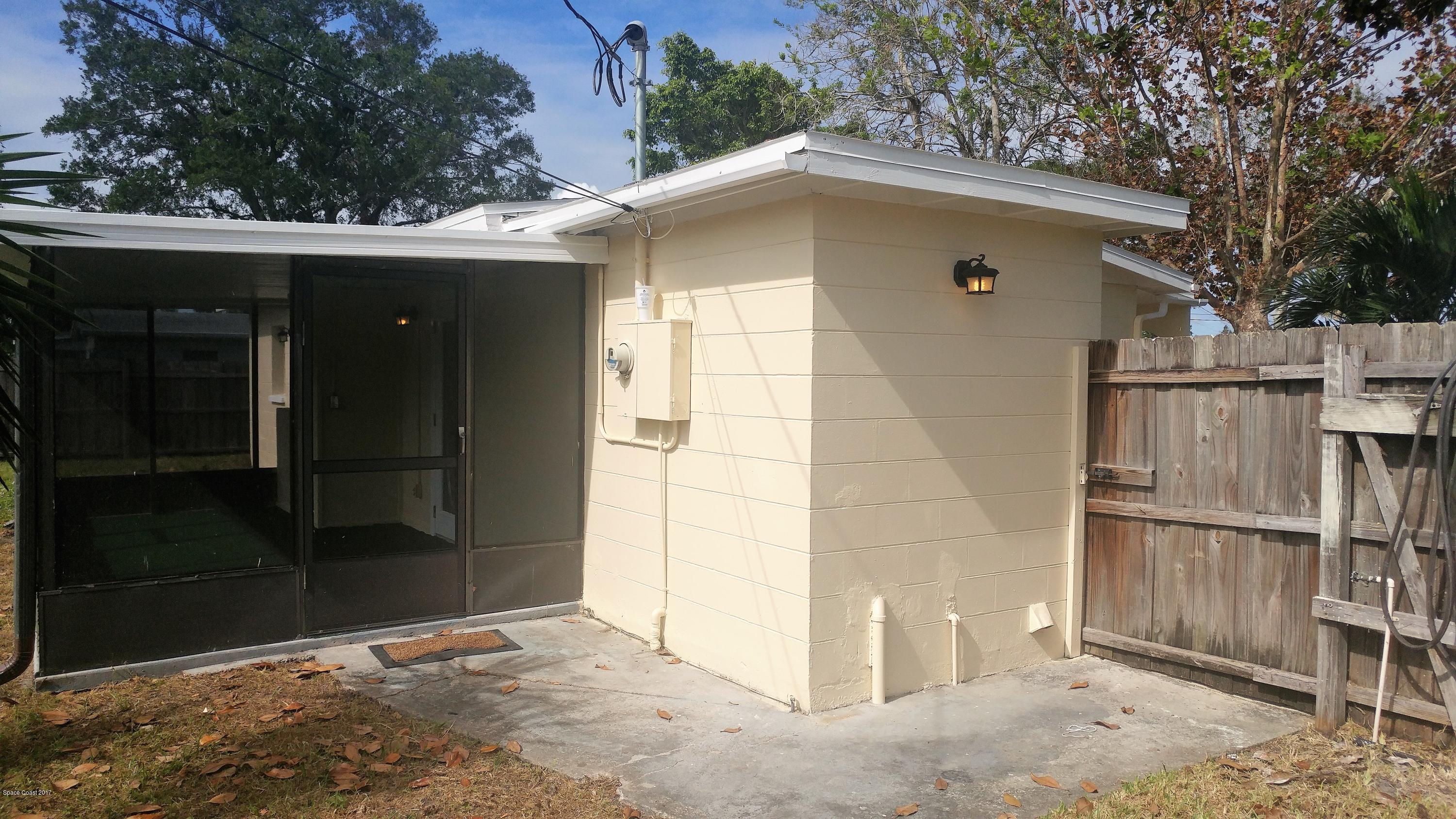 2857 Tropic Road Melbourne, FL 32935 - Photo 9 of 28 a front view of a house with a yard