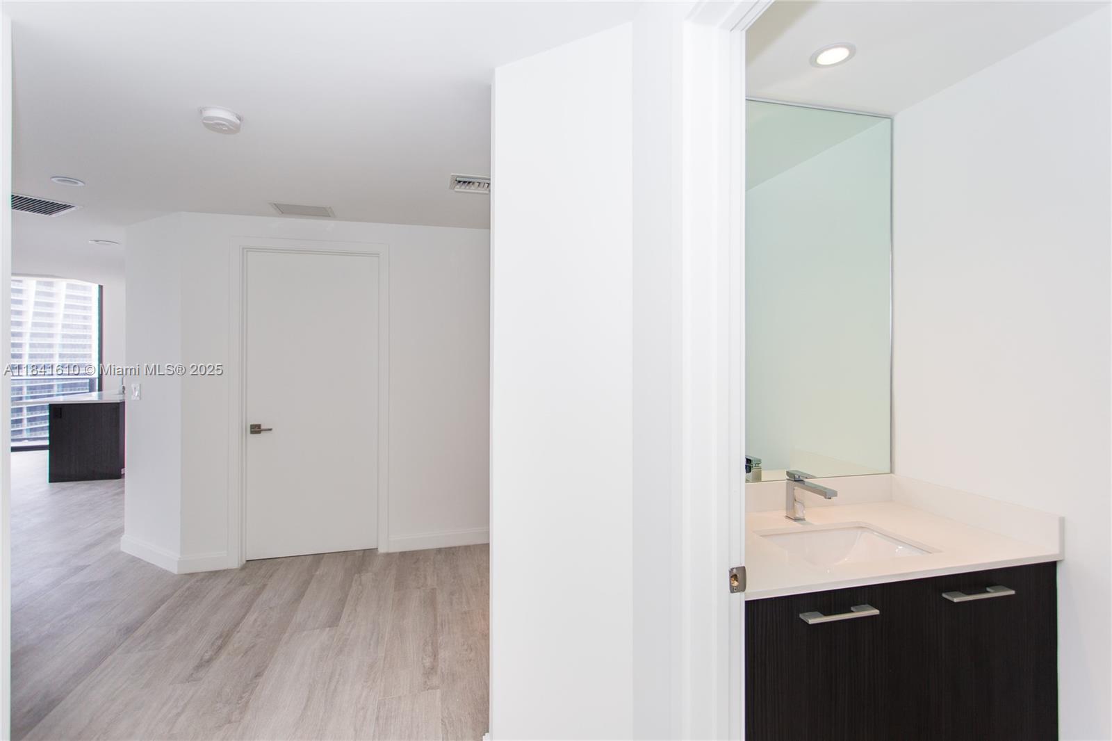 45 Southwest 9th Street, Unit 3803 Miami, FL 33130 - Photo 14 of 54 a bathroom with a sink and a mirror