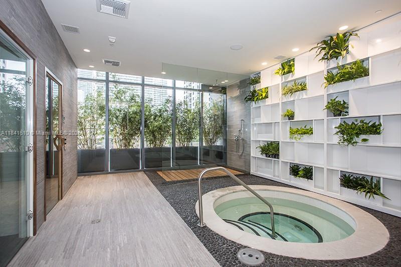 45 Southwest 9th Street, Unit 3803 Miami, FL 33130 - Photo 20 of 54 a room with view of a swimming pool and outdoor seating