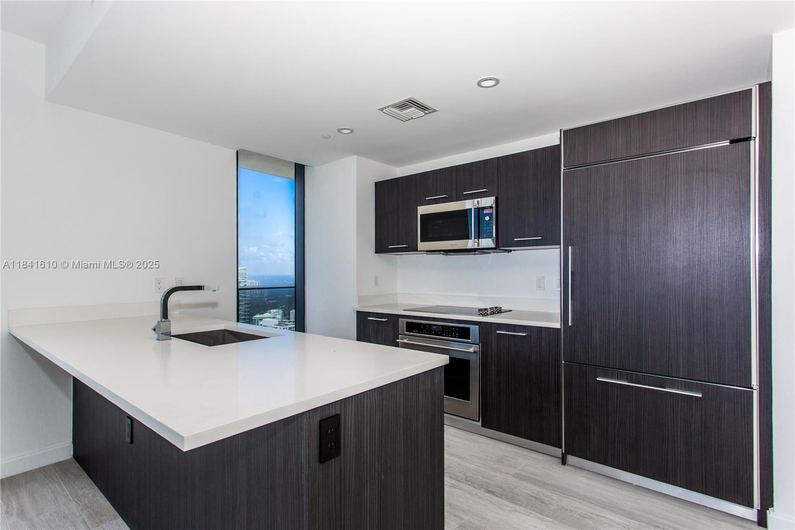 45 Southwest 9th Street, Unit 3803 Miami, FL 33130 - Photo 5 of 54 a kitchen with a sink a stove and refrigerator