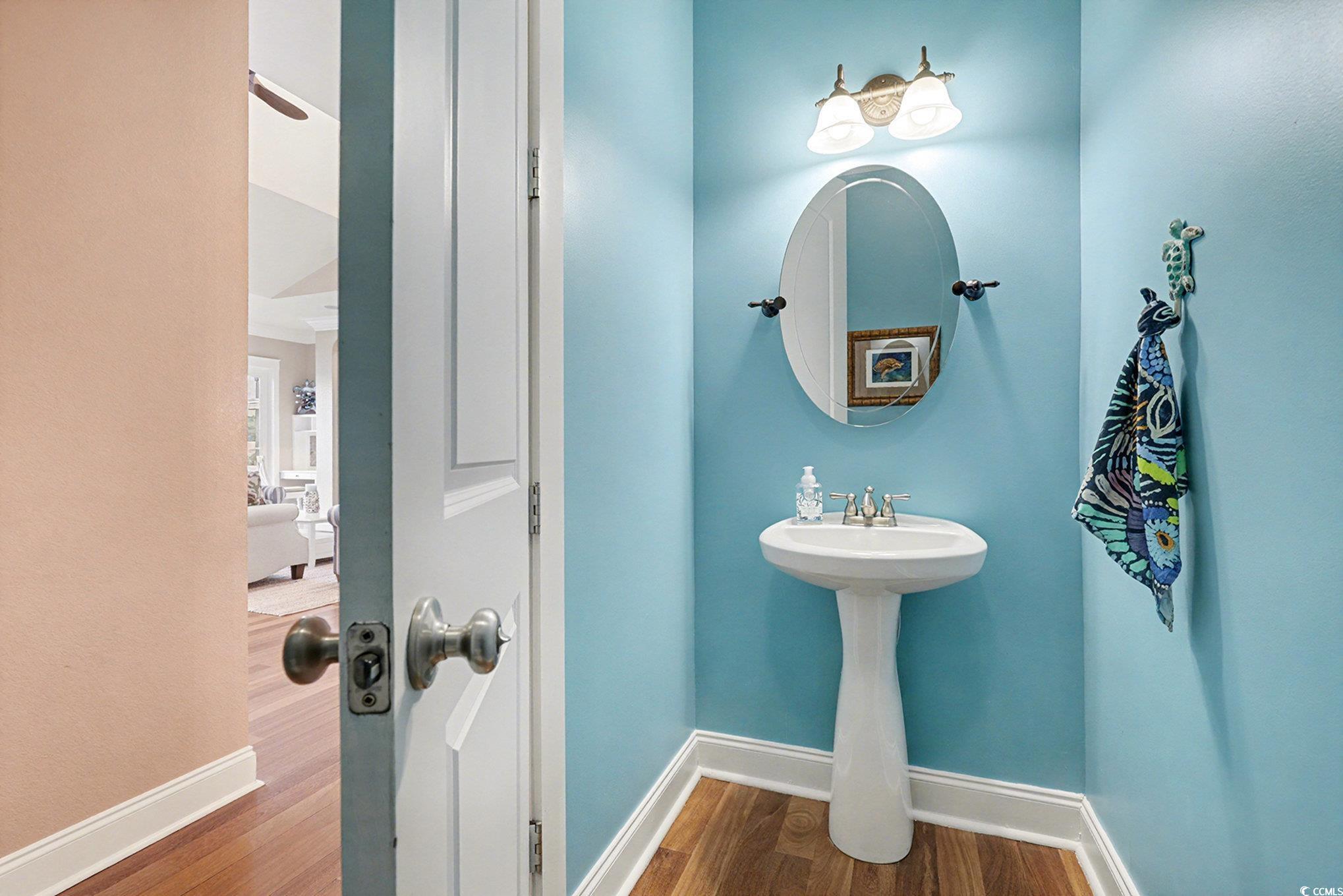 1710 Pond Road Murrells Inlet, SC 29576 - Photo 16 of 39 Half bath with baseboards and Brazilian cherry dark wood-style flooring