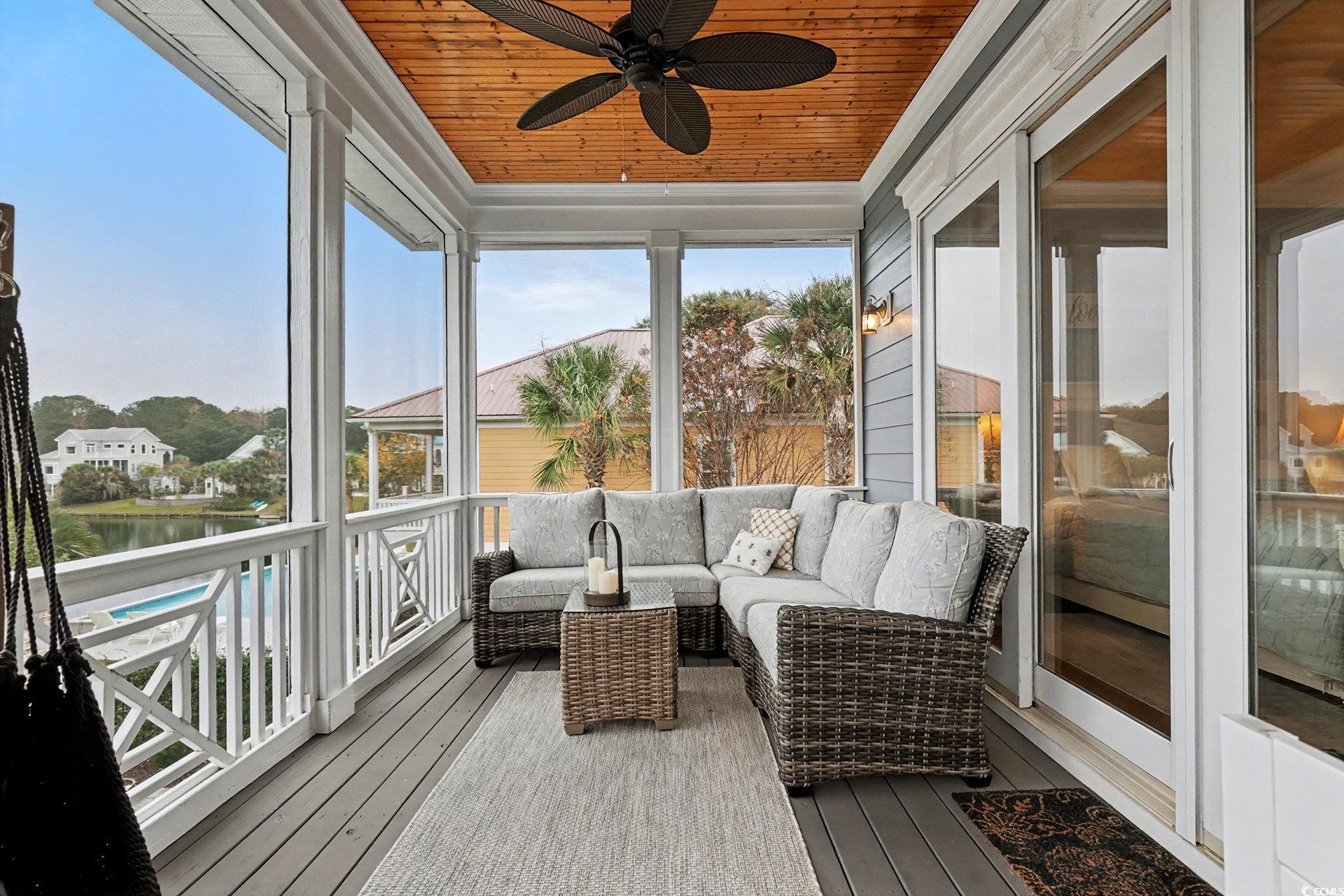 1710 Pond Road Murrells Inlet, SC 29576 - Photo 19 of 39 Sunroom / solarium featuring an outdoor hangout area, wood ceiling, a water view, ceiling fan, and hardwood / wood-style floors