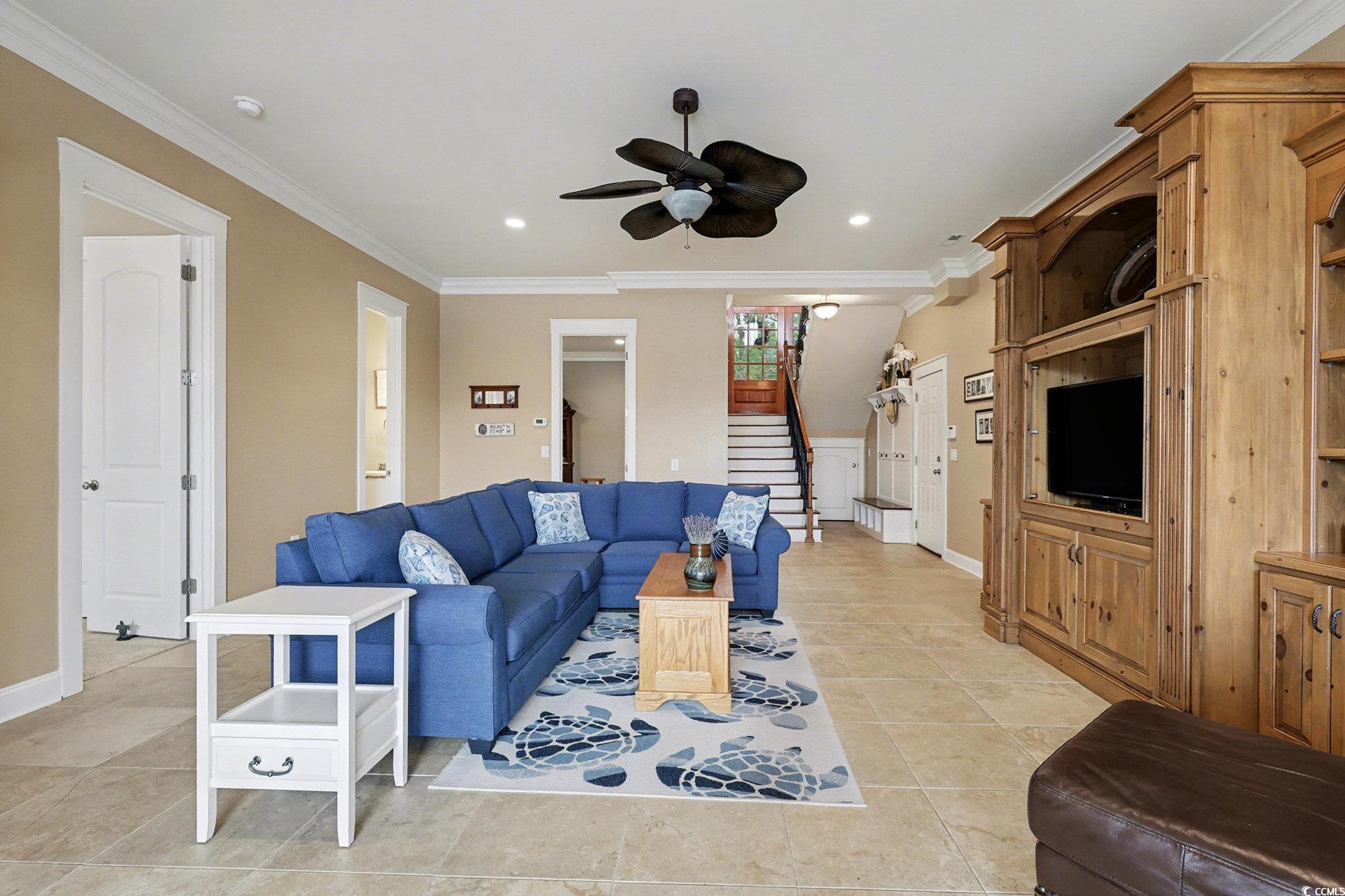 1710 Pond Road Murrells Inlet, SC 29576 - Photo 27 of 39 Living room featuring stairway, crown molding, light tile patterned flooring, and ceiling fan