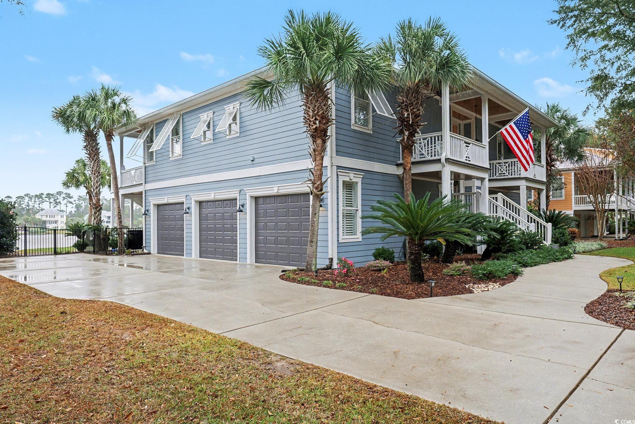 1710 Pond Road Murrells Inlet, SC 29576 - Photo 34 of 39 View of front facade featuring an attached garage, driveway, and a porch
