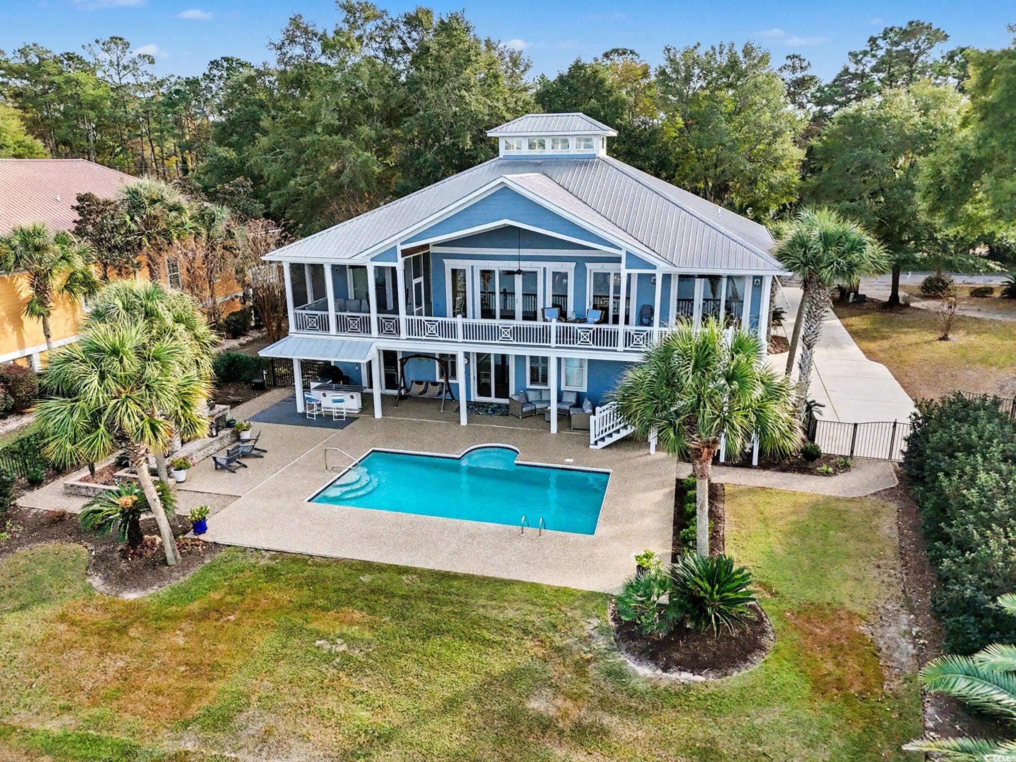 1710 Pond Road Murrells Inlet, SC 29576 - Photo 36 of 39 Rear view of house with a sunroom, stairs, a patio, and a metal roof