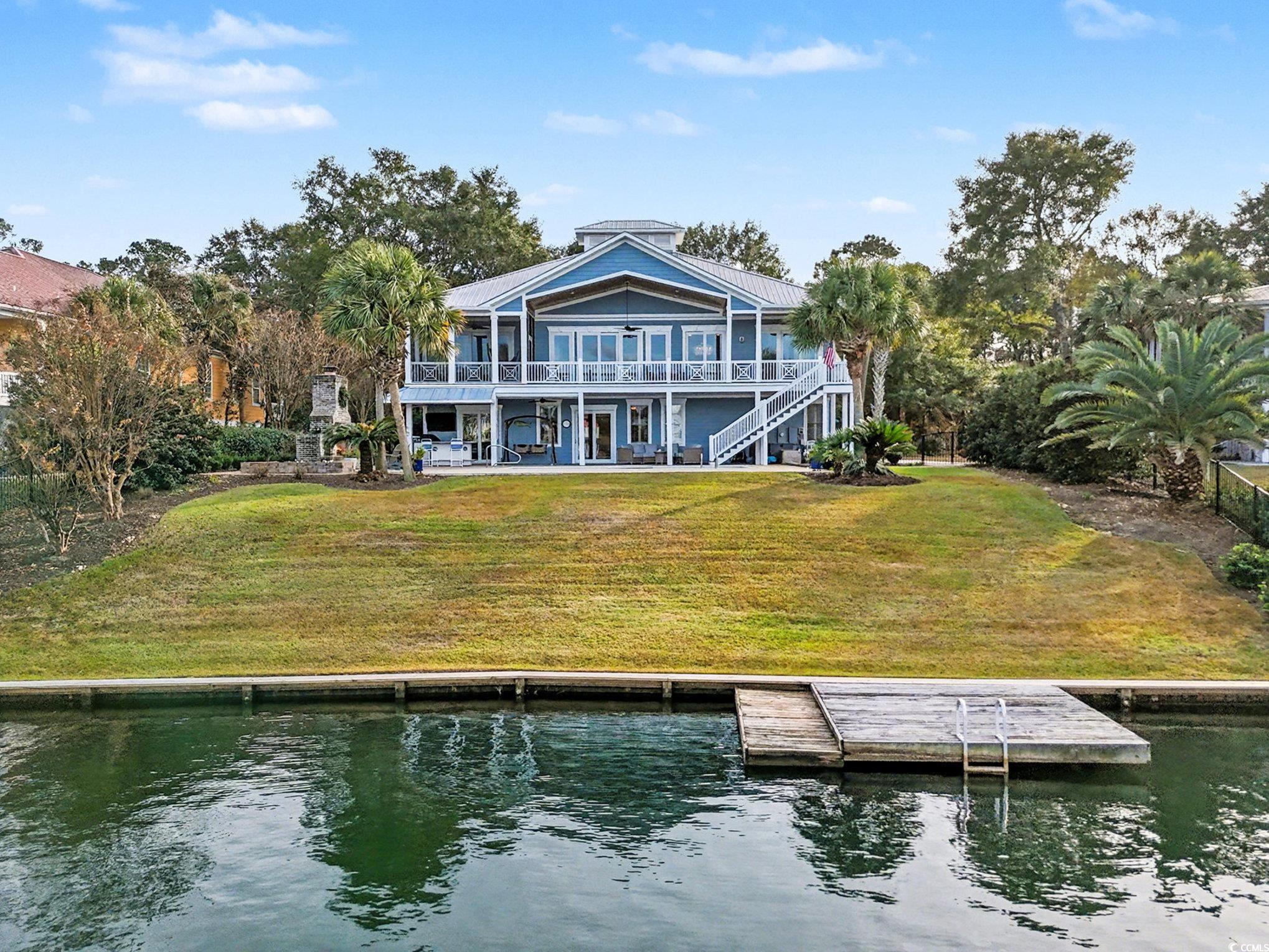 1710 Pond Road Murrells Inlet, SC 29576 - Photo 38 of 39 Back of house with a water view, a yard, and stairs