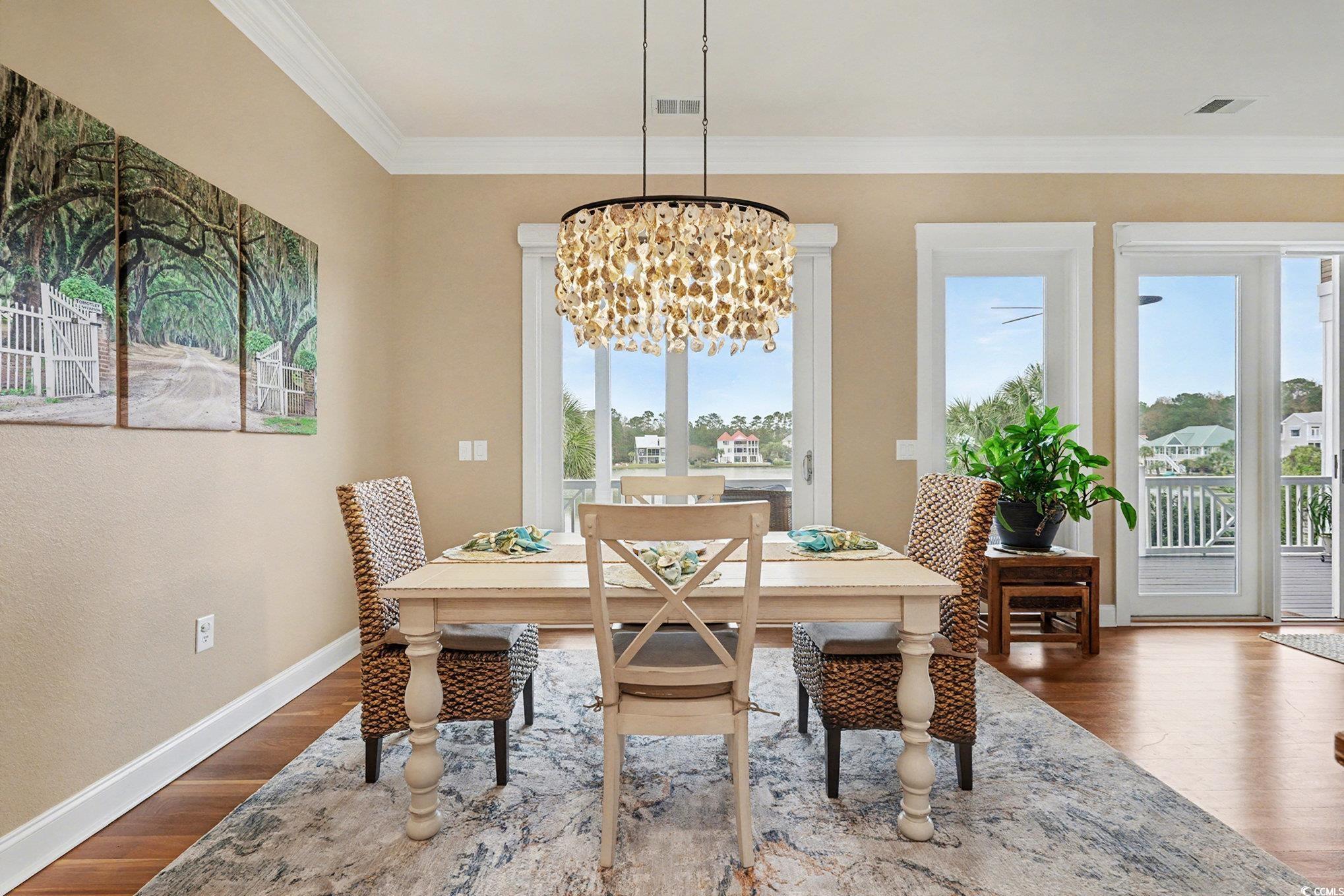 1710 Pond Road Murrells Inlet, SC 29576 - Photo 10 of 39 Dining area featuring a chandelier, Brazilian cherry dark wood-style floors, and crown molding