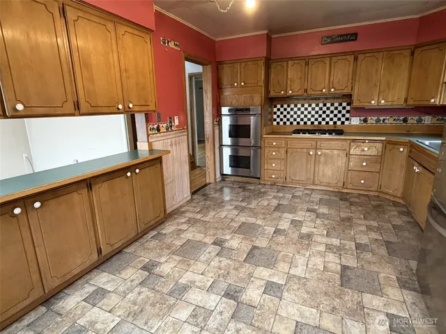 a kitchen with stainless steel appliances granite countertop a sink and cabinets