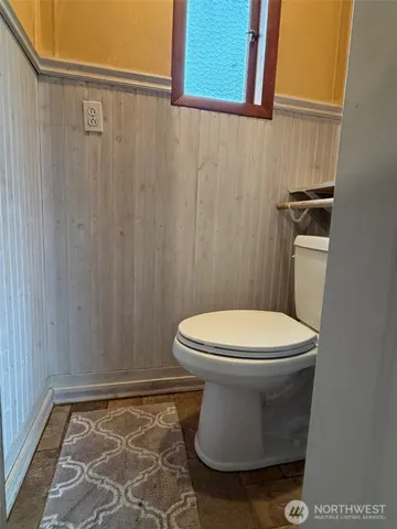 a white toilet sitting next to a shower