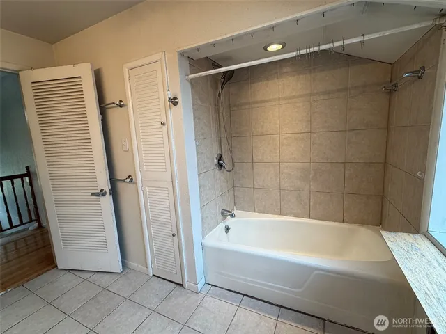 a spacious bathroom with a bathtub and a shower