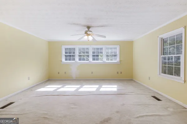 a view of an empty room with a window