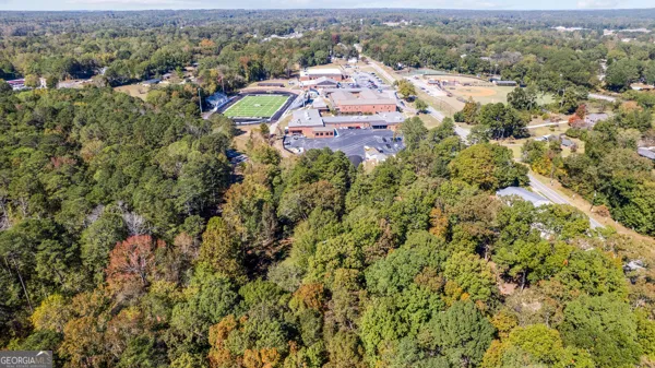 an aerial view of a houses with a swimming pool and mountain view