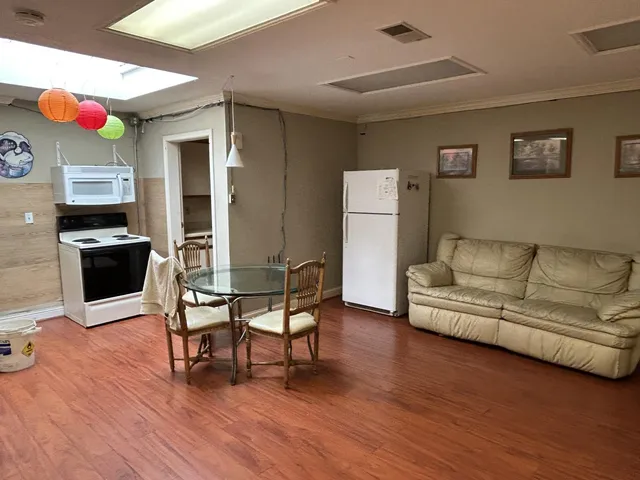 a dining room with furniture and wooden floor