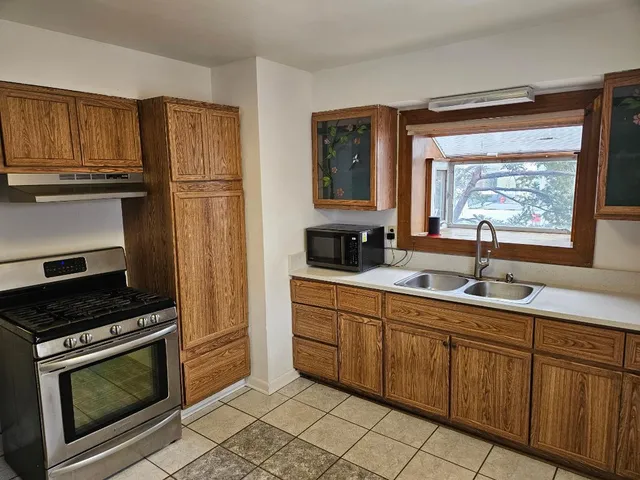 a kitchen with stainless steel appliances a stove sink and cabinets