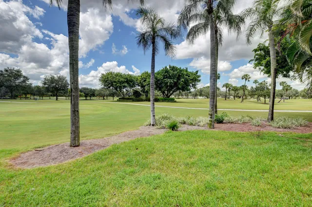 a front view of a house with garden and sitting area
